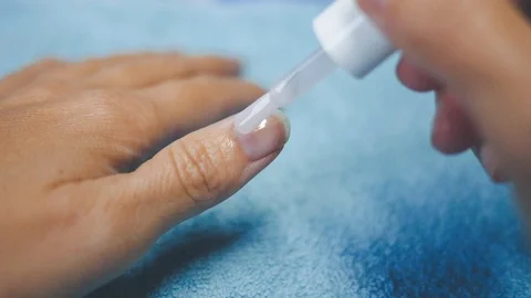 Put tranparent polish on the thumbnail 3 blu background Stock Footage 98739925
