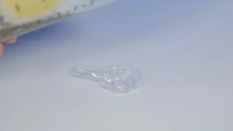 Put transparent urine collection cup on table and collect morning urine Stock Footage 241289096