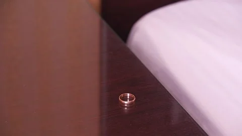 Put the wedding ring on the bedside table Stock Footage 283845694