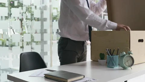 Put the work equipment in the office in a large brown box, Businessmen are ke Stock Footage 155265845
