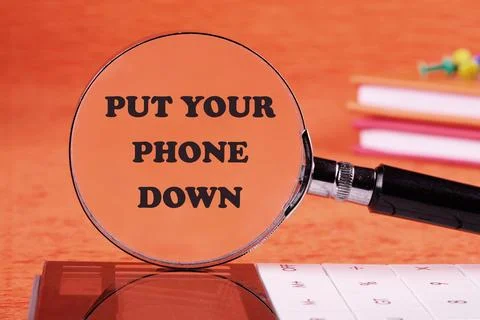 Put Your Phone Down text through a magnifying glass on an orange background Stock Illustration