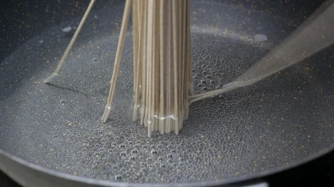 Put Zaru Soba (Cold Soba Japanese Noodles food style) into boiled hot water a Stock Footage 89763298