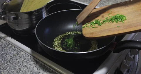 Puting onions in frying pan 스톡 동영상 136134269