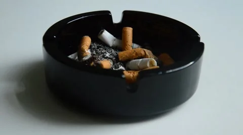 Puting out cigarette in a black ashtray Stock Footage 41030969