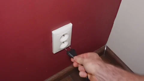 Puting the plug to the EU outlet Stockbeeldmateriaal 166574013