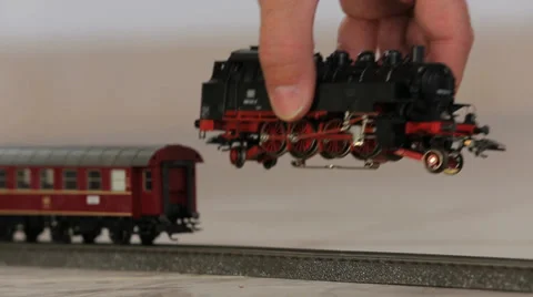 Puting toy train engine on track Stock Footage 37557569