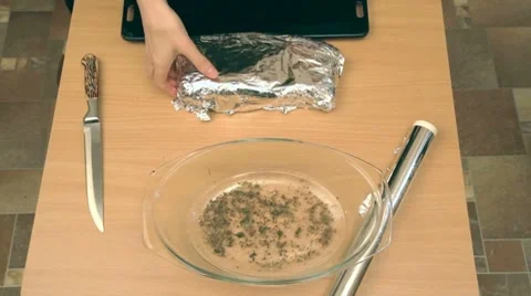 Puting wraped in foil pork on baking sheet, placing in oven Stock-Footage 7740879
