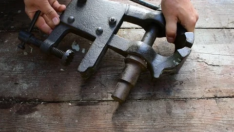 Puts bench vise on the table Stock Footage 116543285