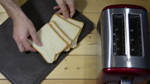 Puts bread for a toast on a table board. Stock Footage 122123259