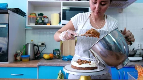 Puts chocolate cream on a cake Stock Footage 75502685