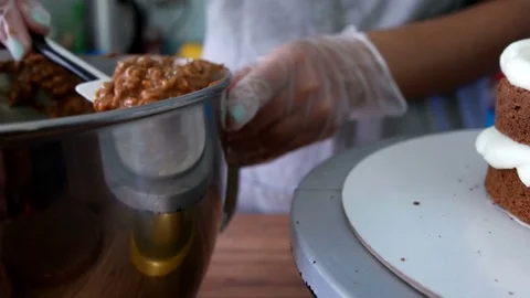 Puts chocolate filling on cake Stock Footage 75508497