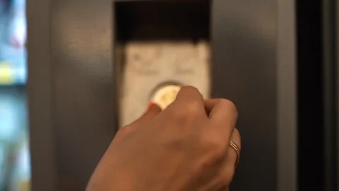 Puts a coin into a snack machine Stock Footage 123738872