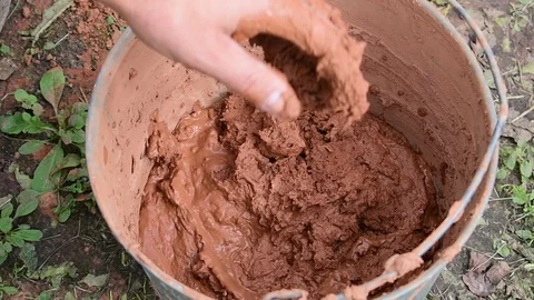 Puts liquid clay in a bucket Stock Footage 117420613