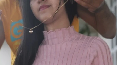 Puts a Necklace Stock Footage 127270359