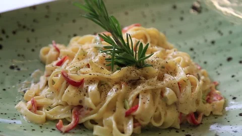 Puts the Parmesan over the pasta dish finished before serving in the restaurant Stock Footage 83591153