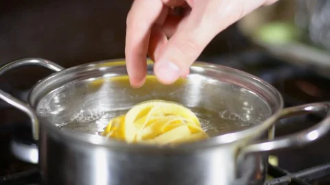 Puts the paste in boiling water Stock Footage 123201880