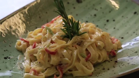 Puts the pepper over the pasta dish finished before serving in the restaurant Stock Footage 83591270