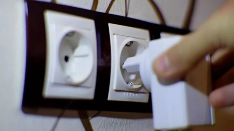 Puts Power Plug In Wall Socket. Wall Outlet. Electrical Socket Stock Footage 258657885