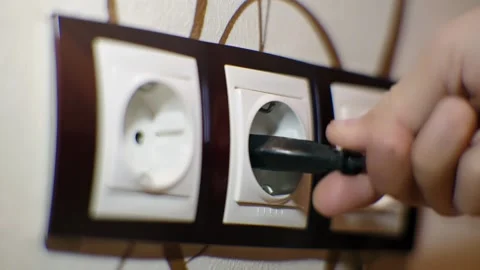 Puts Power Plug In Wall Socket. Wall Outlet. Electrical Socket Stock Footage 258657887