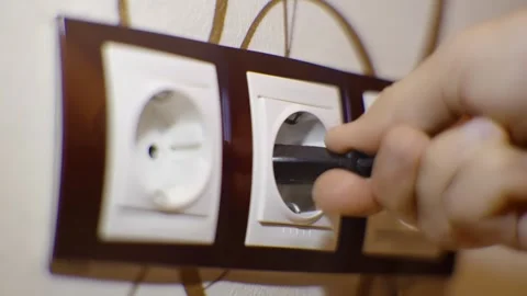 Puts Power Plug In Wall Socket. Wall Outlet. Electrical Socket Stock Footage 259729855
