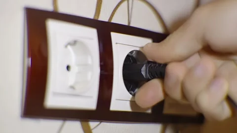 Puts Power Plug In Wall Socket. Wall Outlet. Electrical Socket Stock Footage 259730038