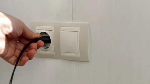 Puts Power Plug In Wall Socket. Wall Outlet. Electrical Socket Stock Footage 261267652