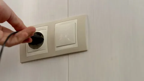 Puts Power Plug In Wall Socket. Wall Outlet. Electrical Socket Stock Footage 261267738
