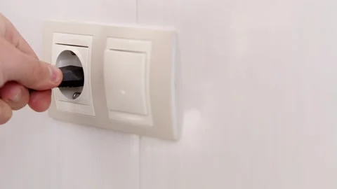 Puts Power Plug In Wall Socket. Wall Outlet. Electrical Socket Stock Footage 261293227