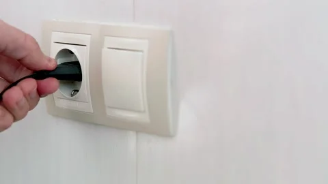 Puts Power Plug In Wall Socket. Wall Outlet. Electrical Socket Stock Footage 262421822
