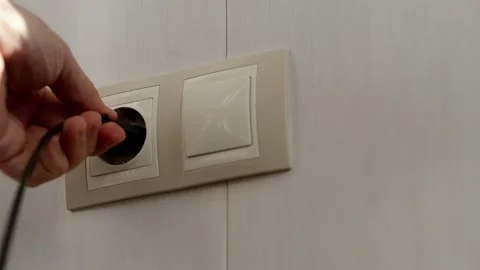 Puts Power Plug In Wall Socket. Wall Outlet. Electrical Socket Stock Footage 262422088