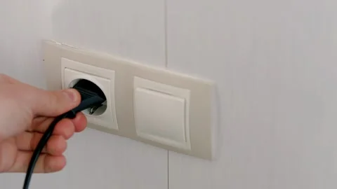 Puts Power Plug In Wall Socket. Wall Outlet. Electrical Socket Stock Footage 262884019