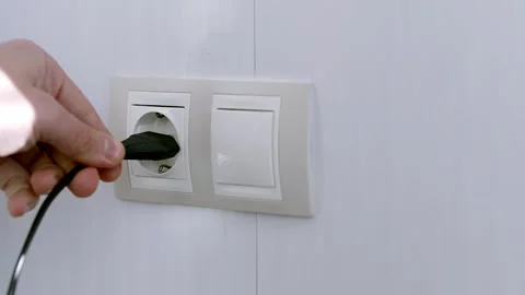 Puts Power Plug In Wall Socket. Wall Outlet. Electrical Socket Stock Footage 263129596