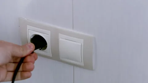 Puts Power Plug In Wall Socket. Wall Outlet. Electrical Socket Stock Footage 263129620