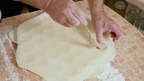 Puts the stuffing on the dough Stock Footage 80043600