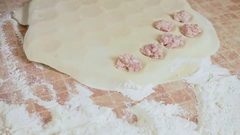 Puts the stuffing on the dough hd Stock Footage 80043615