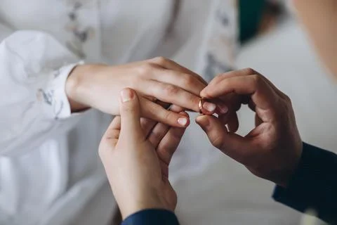 Puts a wedding ring on his finger Stock Photos