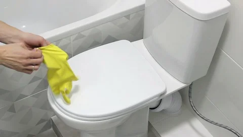 Puts On The Yellow Gloves For Start Cleaning The Toilet. Thumb Up Stock Footage 127982661