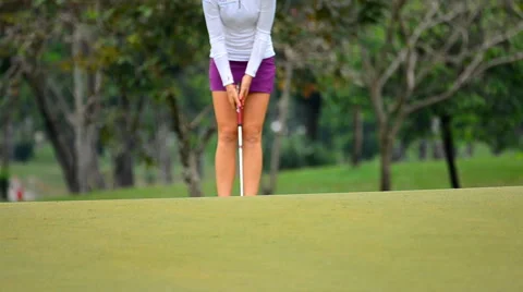 Putt Golf ball going into the hole. Video stock 55627994