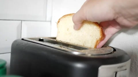Putting 2 sliced bread in toaster Stock Footage 246840806