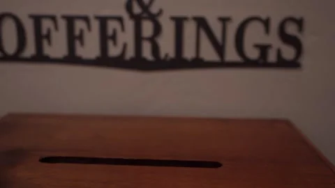 Putting a $20 bill into the offering box at church Stock Footage 261305306