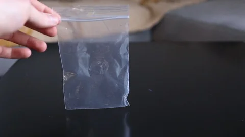 Putting a 20 euro banknote inside a small plastic hygienic bag Stock Footage 129259889
