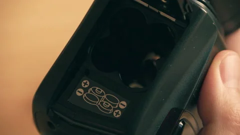 Putting in the AA batteries Stock Footage 146351189