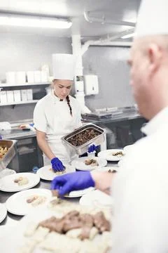 Putting all the elements together. chefs preparing a meal service in a Stock Photos