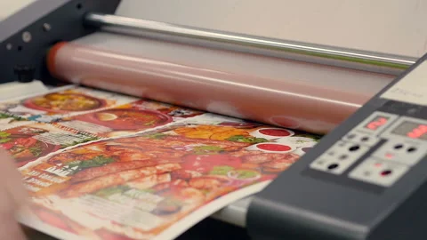 Putting and insert laminating film with paper in laminator Stock Footage 116706136