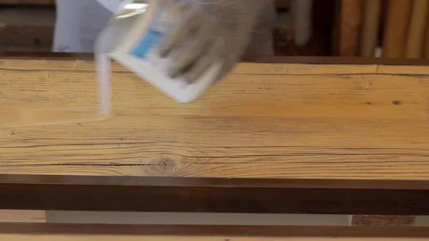 Putting and Rolling out Epoxy Resin on a Wooden Board Video stock 89773739