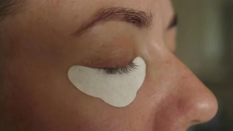 Putting apply applying eye protection paper papers under eye Stock-Footage 134286842