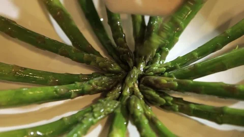 Putting asparagus on a plate Stock Footage 71732571