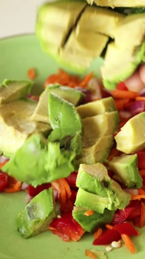 Putting avocado in dish Stock Footage 247328987