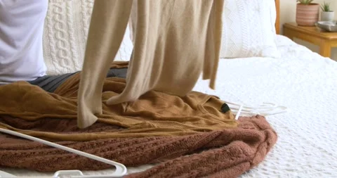 Putting away winter clothes Stock Footage 146815467