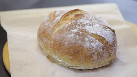 Putting baked bread on the grill Stock Footage 121120830